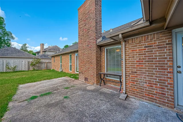 a view of backyard of house and wooden deck