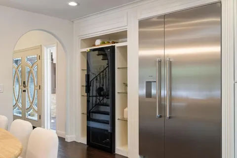 a bathroom with a glass door shower a mirror and a sink