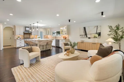 a living room with furniture large window and a fireplace