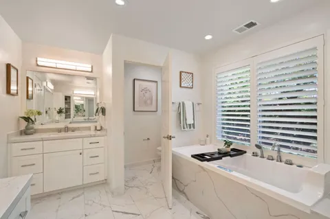 a bedroom with a bed and a couch