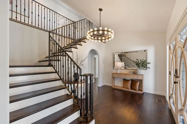 a view of entryway and hall with wooden floor
