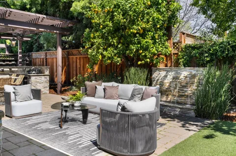 a view of a patio with table and chairs and potted plants