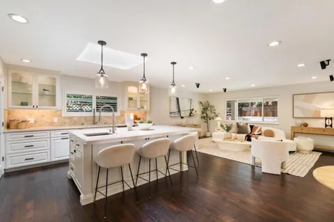 a large kitchen with a large counter top appliances and cabinets