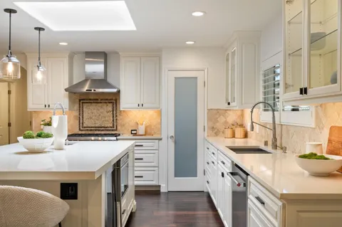a kitchen with a sink stove and refrigerator