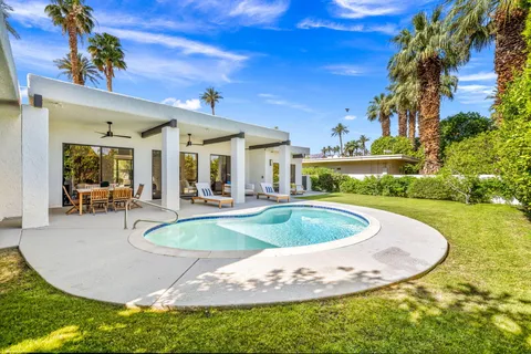 a view of a swimming pool with a yard