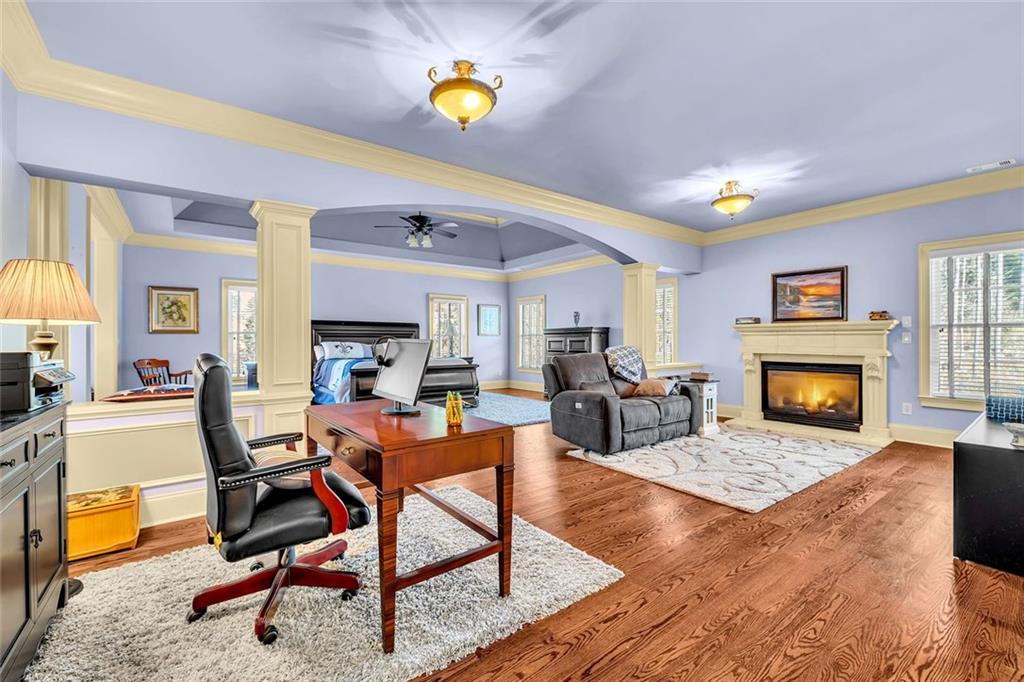 245 Arledge Lane Southwest Atlanta, GA 30331 - Photo 19 of 47 a living room with furniture a fireplace and a dining table with wooden floor