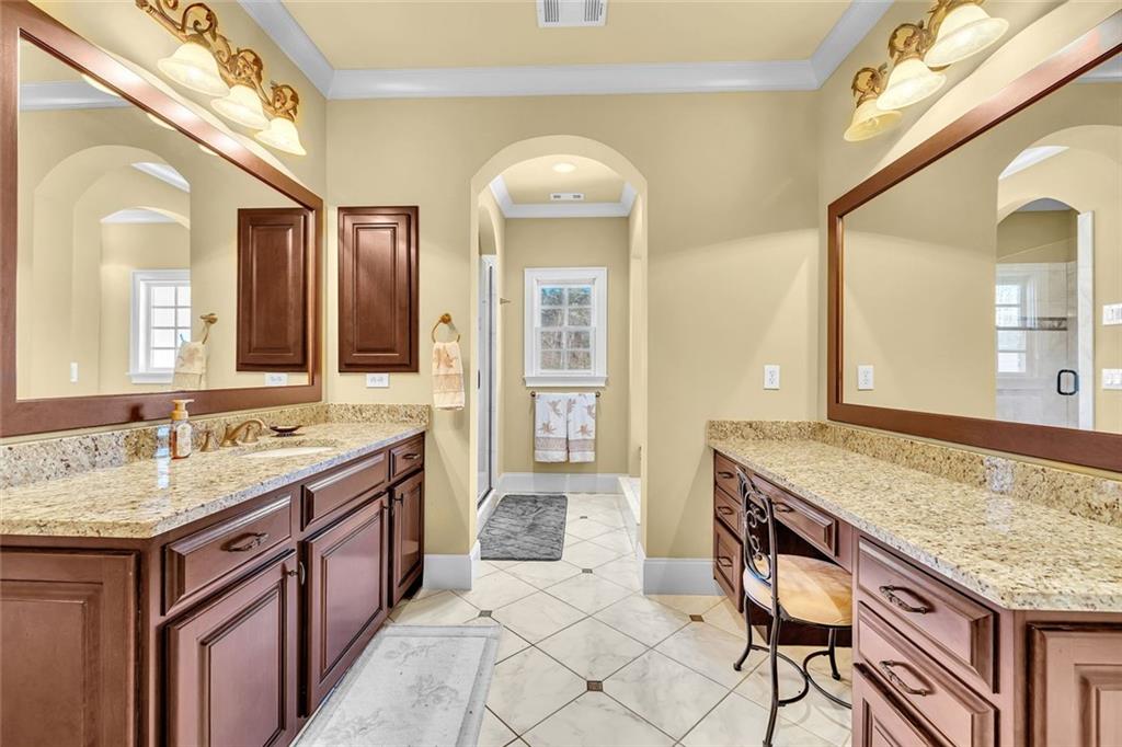 245 Arledge Lane Southwest Atlanta, GA 30331 - Photo 26 of 47 a spacious bathroom with a granite countertop sink and a mirror