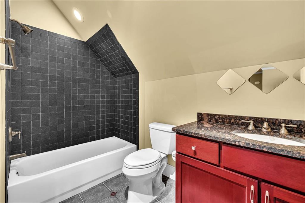 245 Arledge Lane Southwest Atlanta, GA 30331 - Photo 34 of 47 a bathroom with a granite countertop bathtub sink vanity mirror and toilet