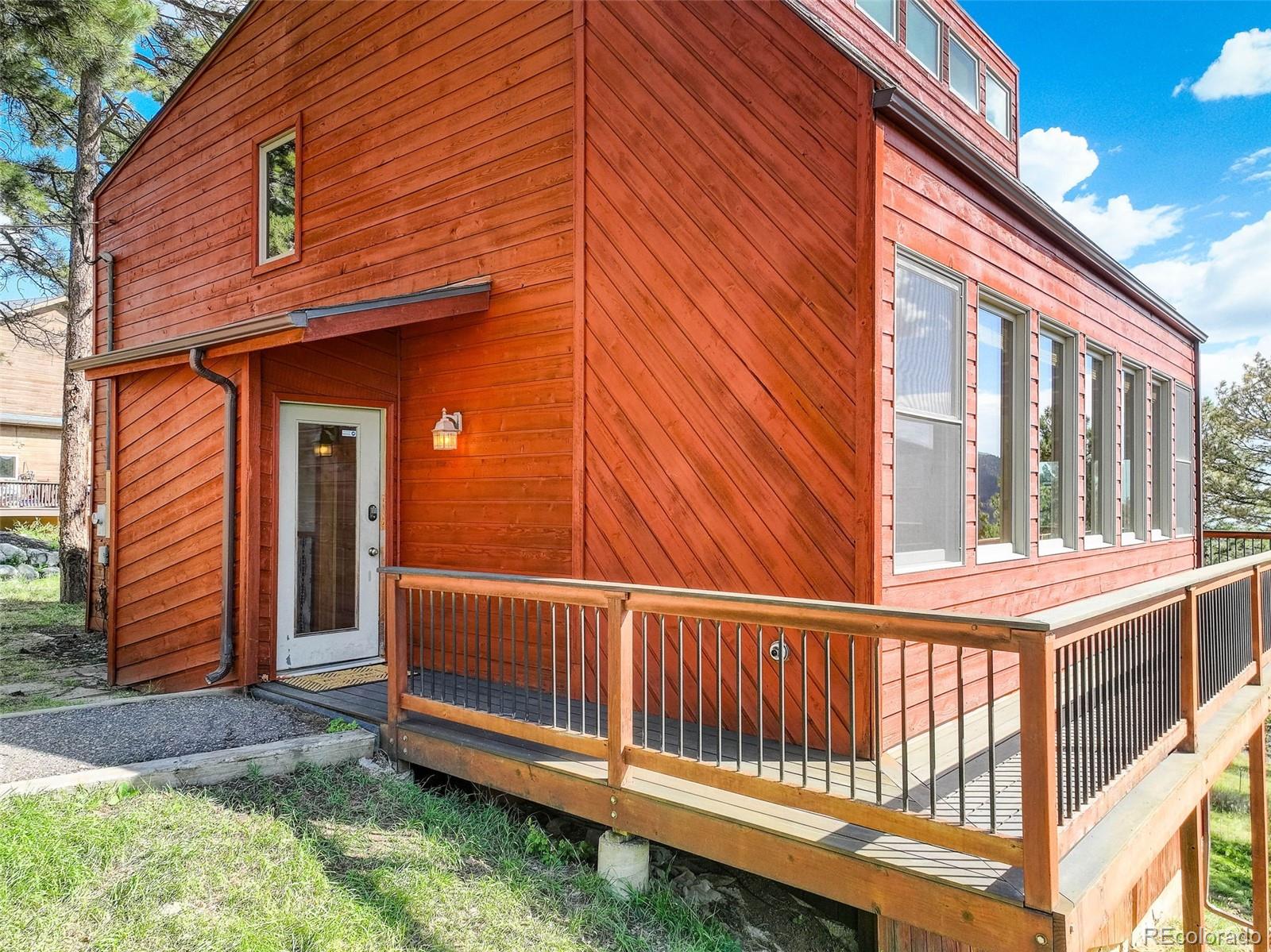 a view of a house with a small yard and wooden fence