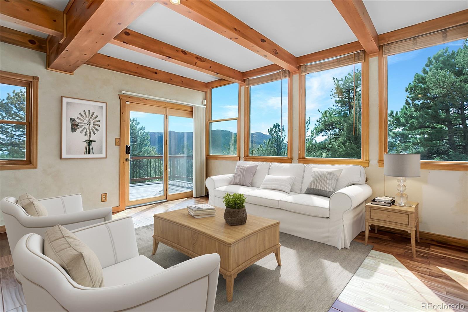 9209 Fallen Rock Road Conifer, CO 80433 - Photo 12 of 33 a living room with furniture and a large window