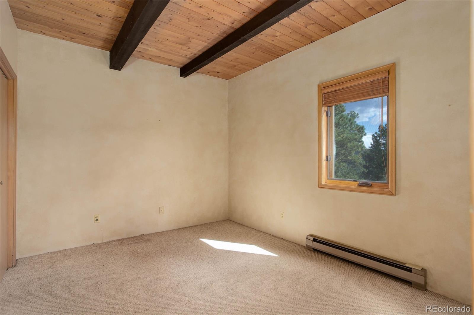 9209 Fallen Rock Road Conifer, CO 80433 - Photo 15 of 33 a view of a hallway with a window