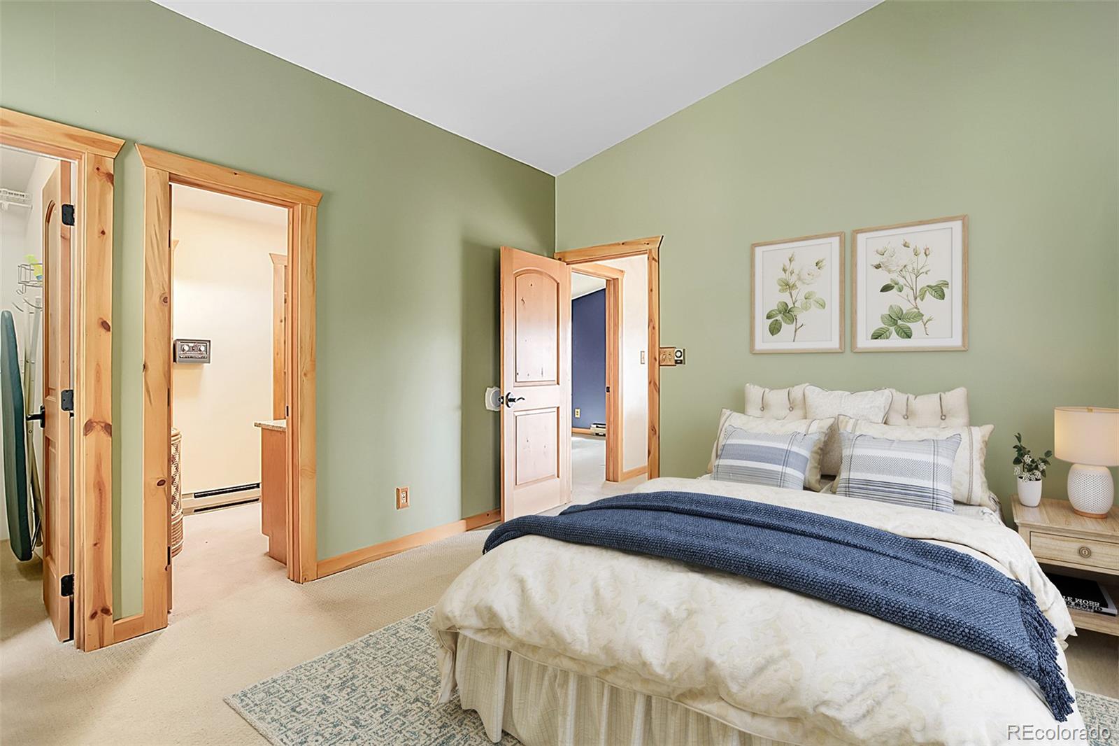 9209 Fallen Rock Road Conifer, CO 80433 - Photo 20 of 33 a bedroom with a bed and painting on the wall