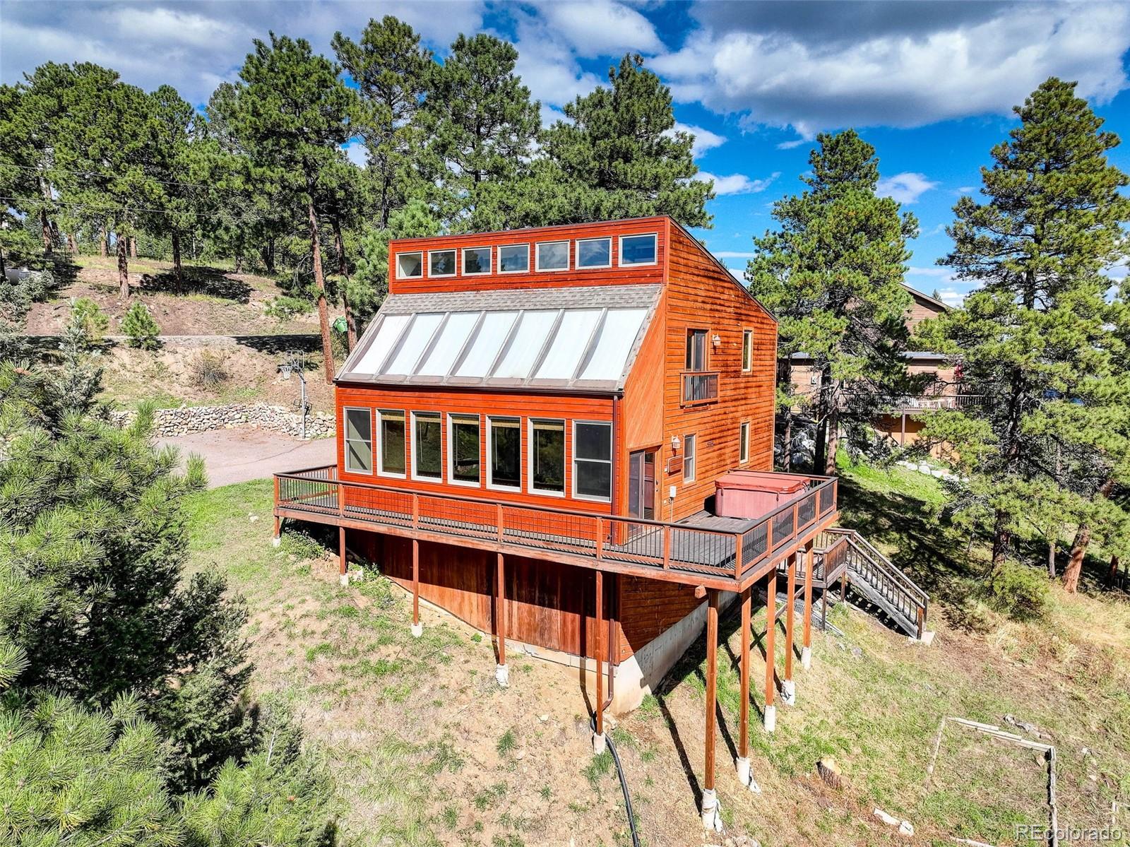 9209 Fallen Rock Road Conifer, CO 80433 - Photo 2 of 33 a balcony with a table and chairs