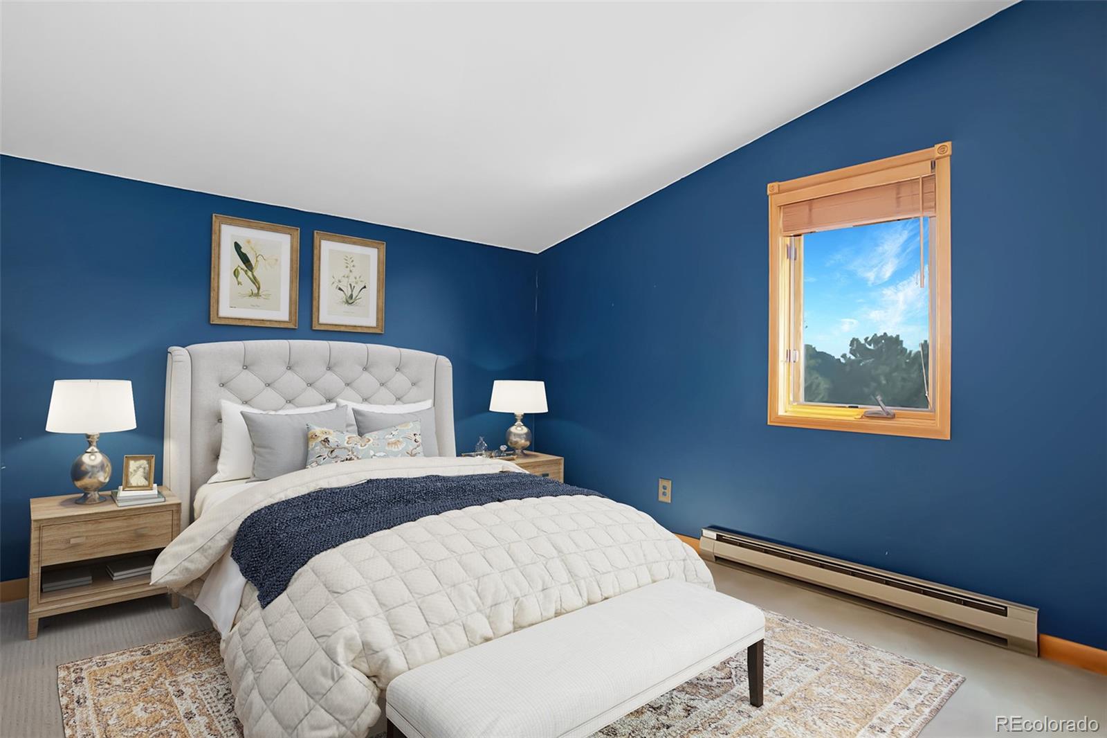 9209 Fallen Rock Road Conifer, CO 80433 - Photo 22 of 33 a bedroom with a bed and a painting on the wall