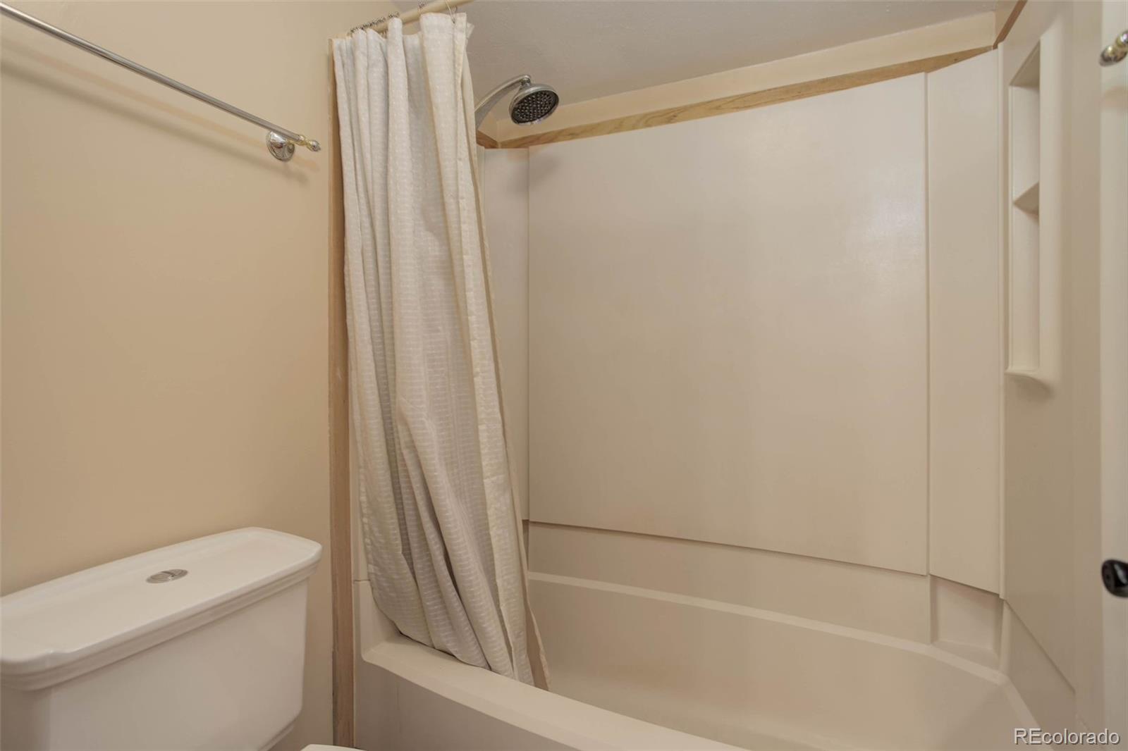 9209 Fallen Rock Road Conifer, CO 80433 - Photo 24 of 33 a bathroom with a shower and a toilet