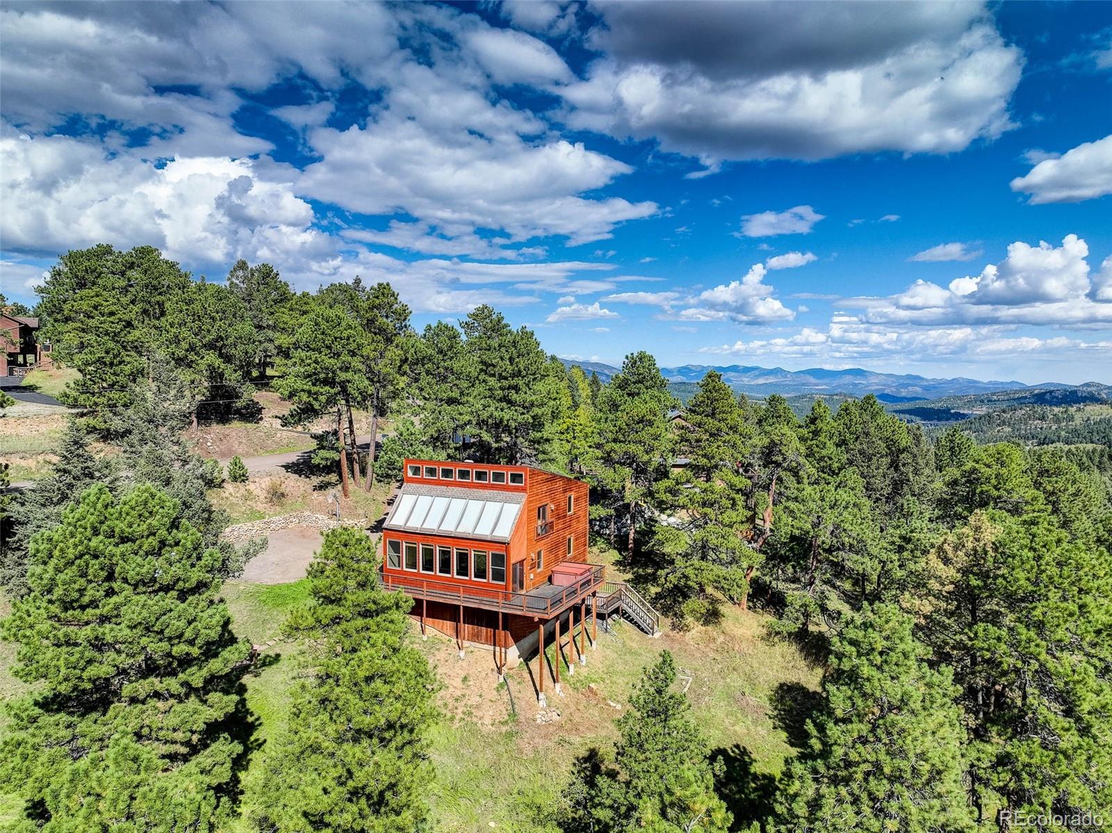9209 Fallen Rock Road Conifer, CO 80433 - Photo 3 of 33 a balcony with furniture and city view