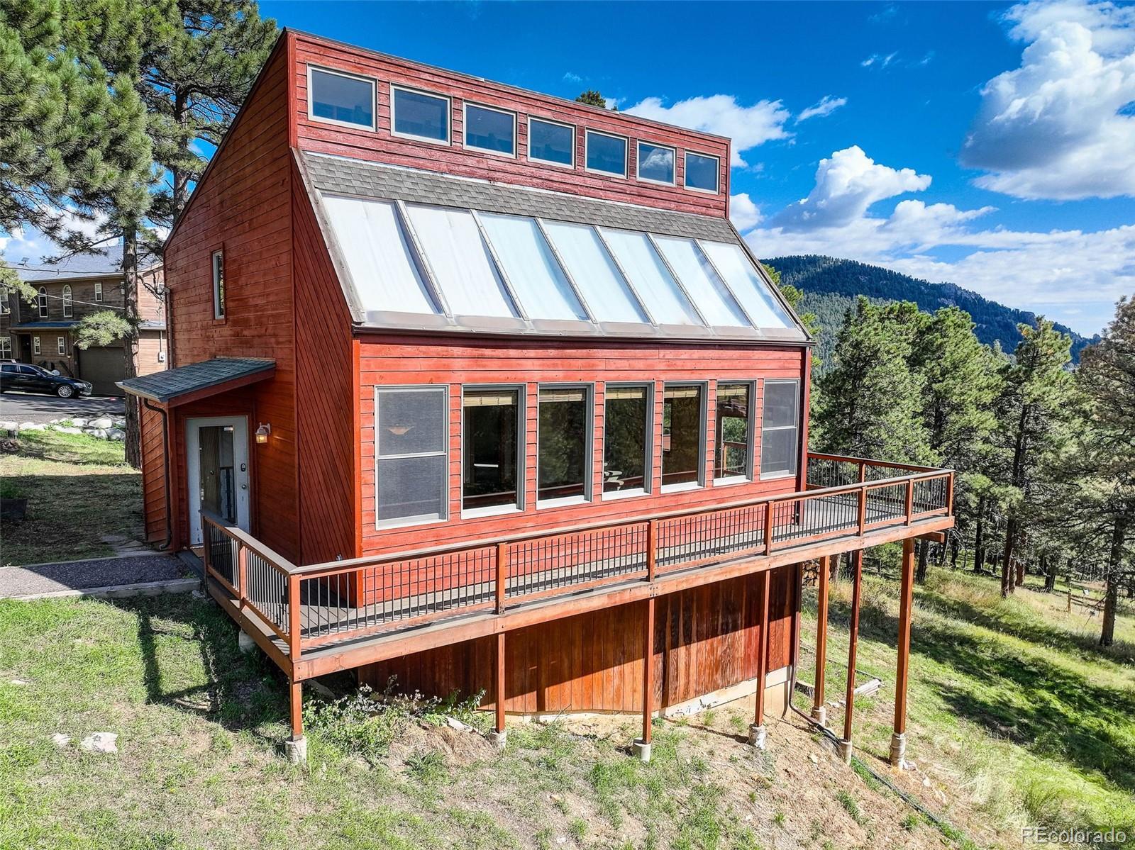 9209 Fallen Rock Road Conifer, CO 80433 - Photo 33 of 33 a view of a house with backyard and sitting area