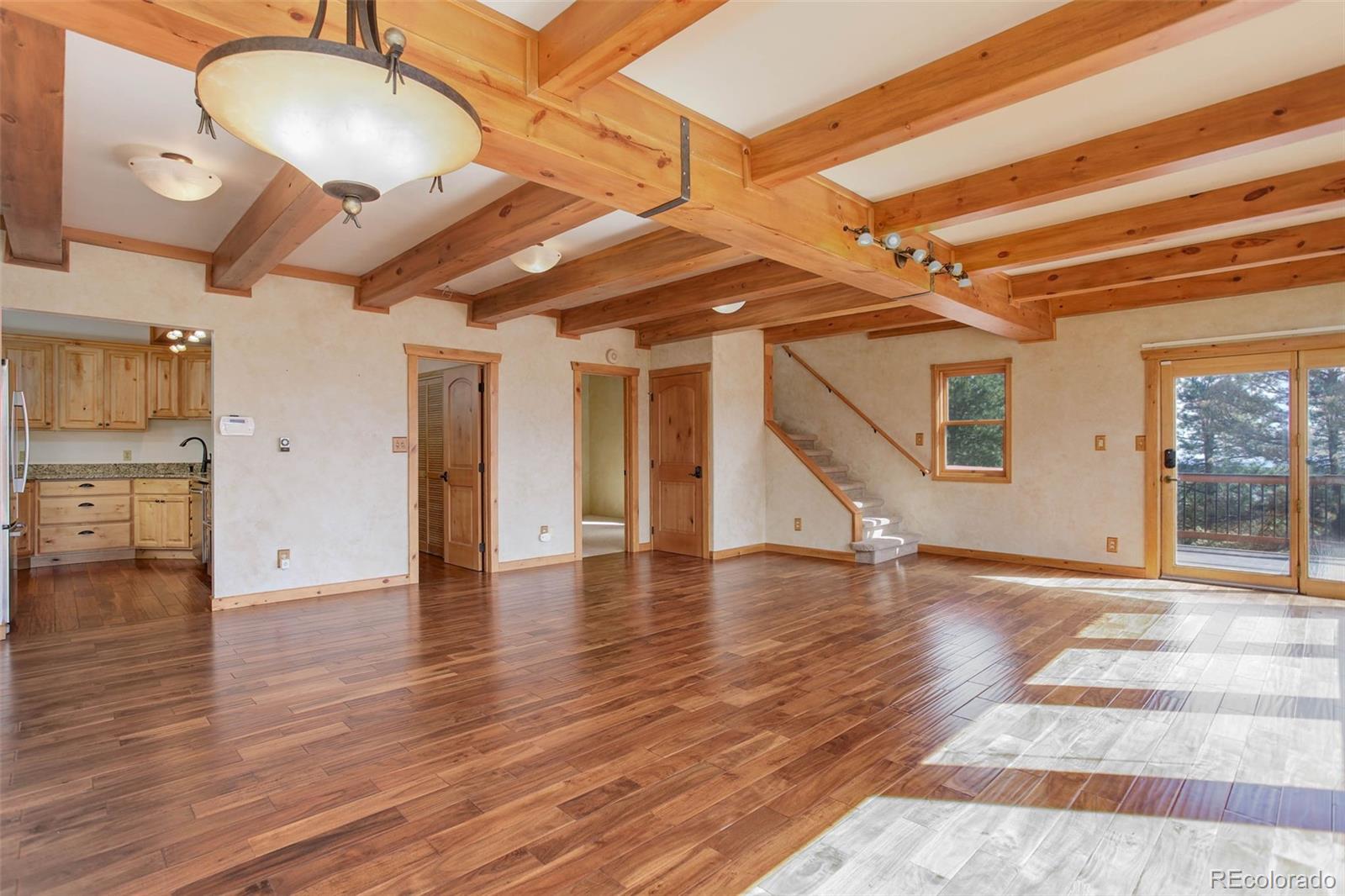 9209 Fallen Rock Road Conifer, CO 80433 - Photo 6 of 33 a view of a room with wooden floor