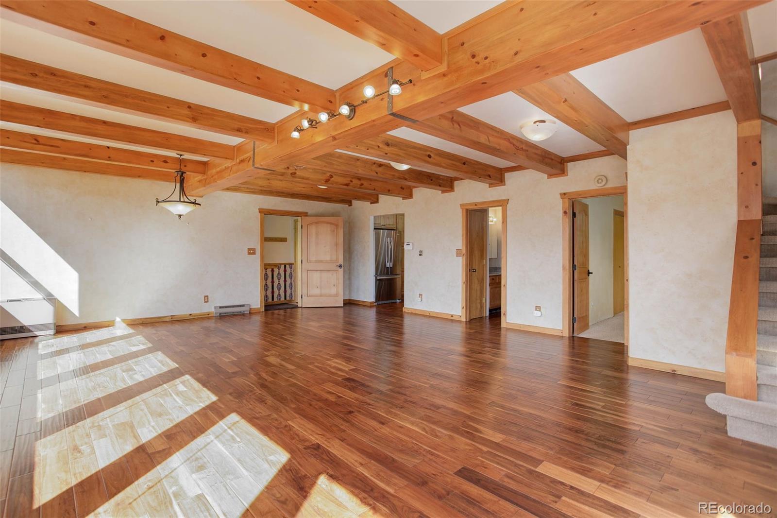 9209 Fallen Rock Road Conifer, CO 80433 - Photo 8 of 33 a view of empty room with wooden floor