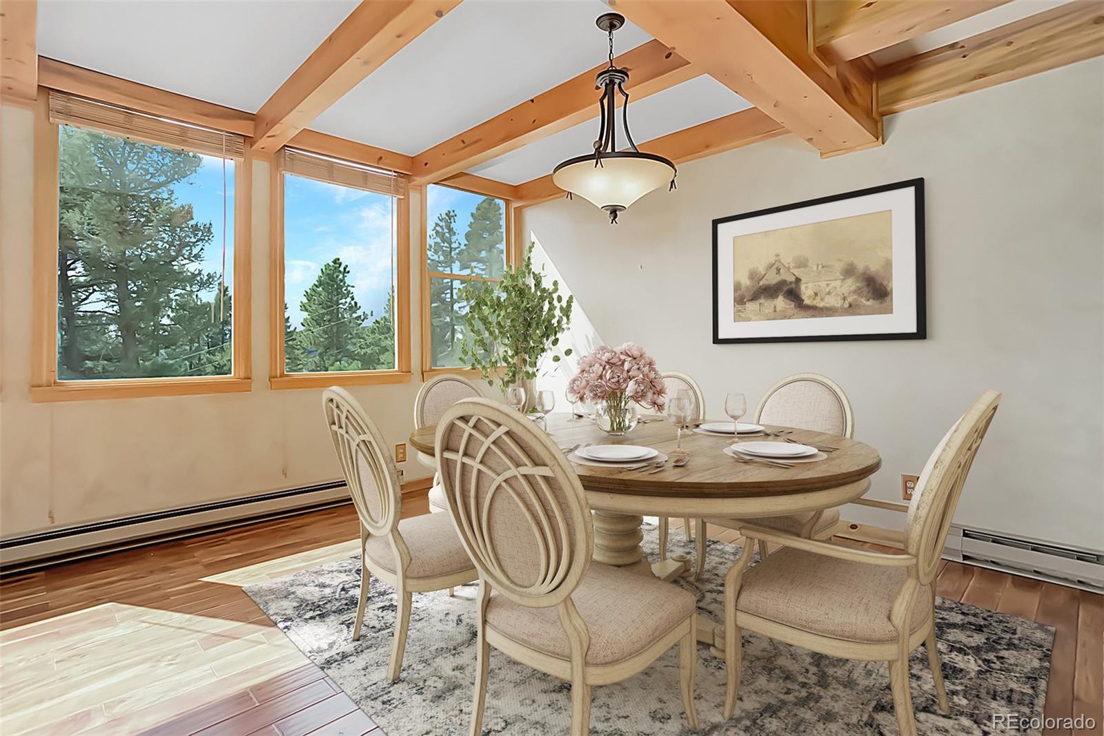 9209 Fallen Rock Road Conifer, CO 80433 - Photo 10 of 33 a view of a dining room with furniture window and wooden floor