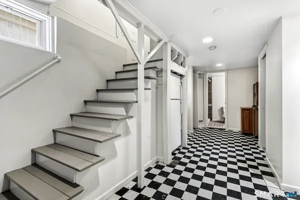 a view of a hallway with wooden floor and white walls