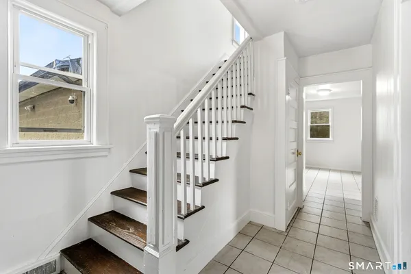 a view of entryway with wooden floor and bathroom