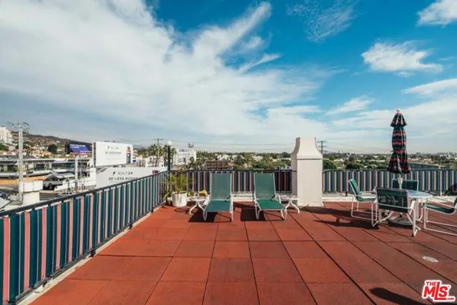 a view of a swimming pool with outdoor seating