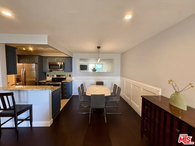 a living room with furniture a flat screen tv and a floor to ceiling window