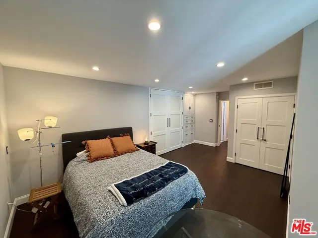 a bathroom with a granite countertop sink a mirror and toilet