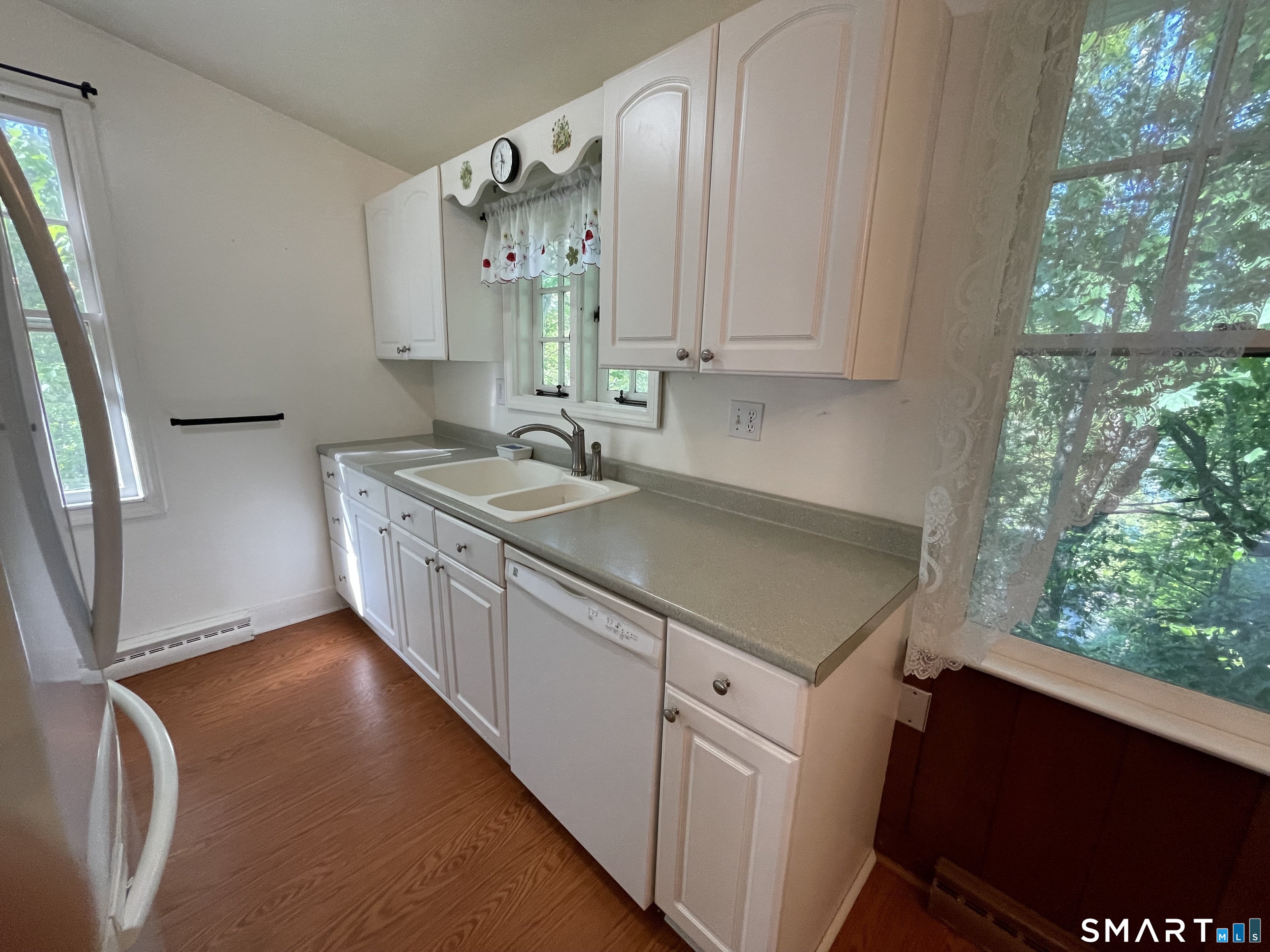 89 Alpine Drive Newtown, CT 06482 - Photo 15 of 32 a kitchen with a sink stove and cabinets