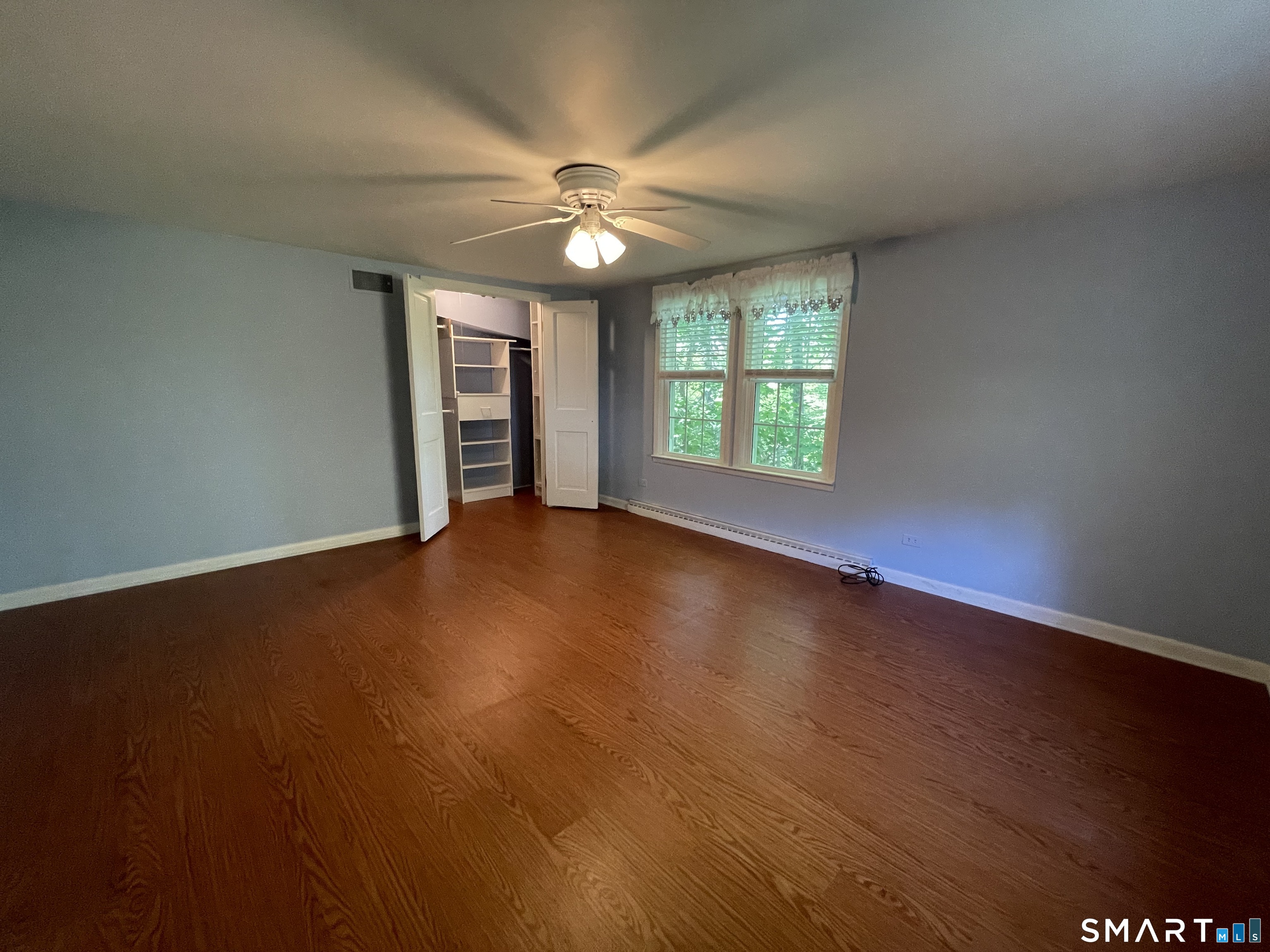 89 Alpine Drive Newtown, CT 06482 - Photo 21 of 32 an empty room with wooden floor fan and windows