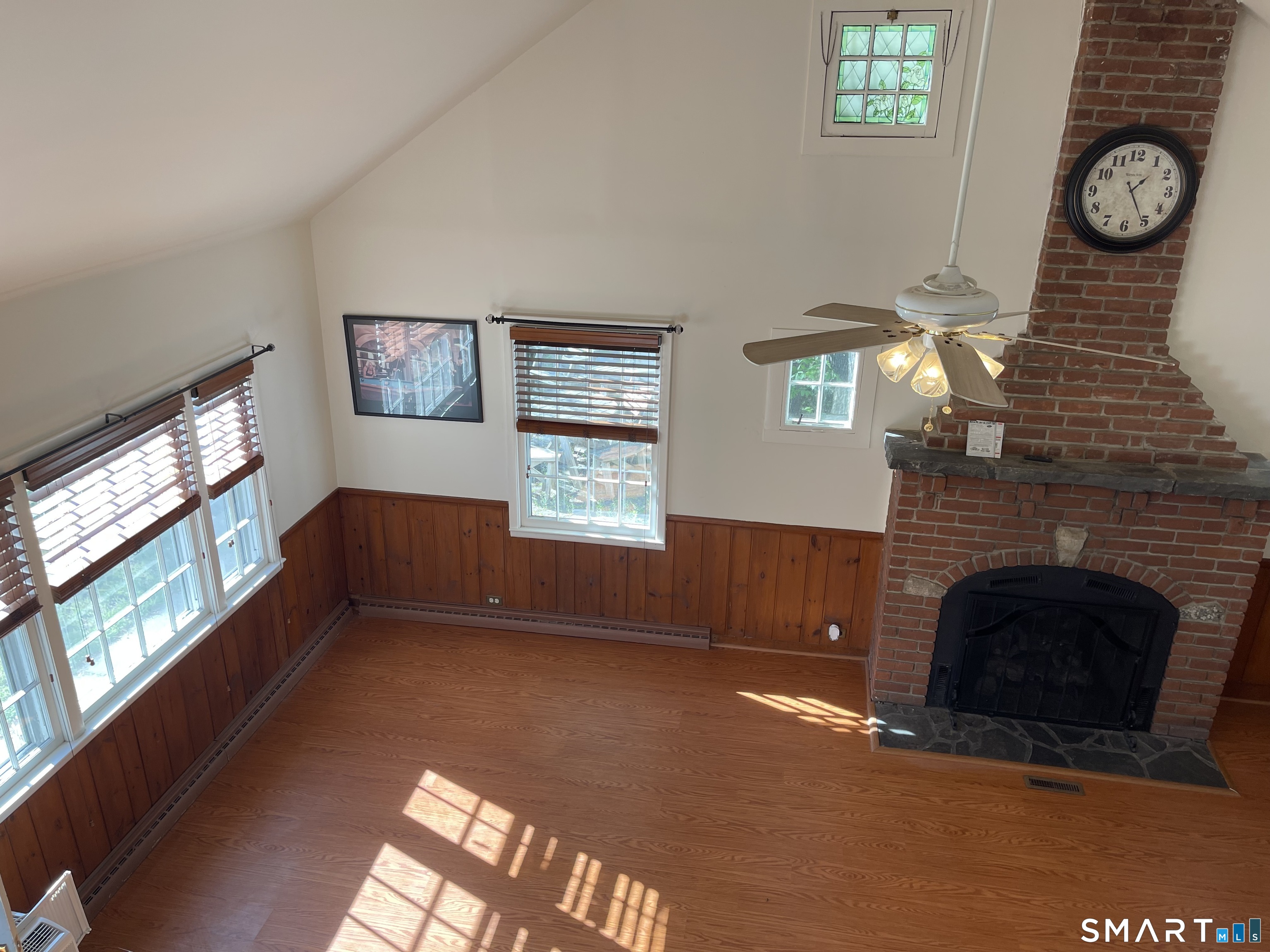 89 Alpine Drive Newtown, CT 06482 - Photo 25 of 32 an empty room with windows and fireplace