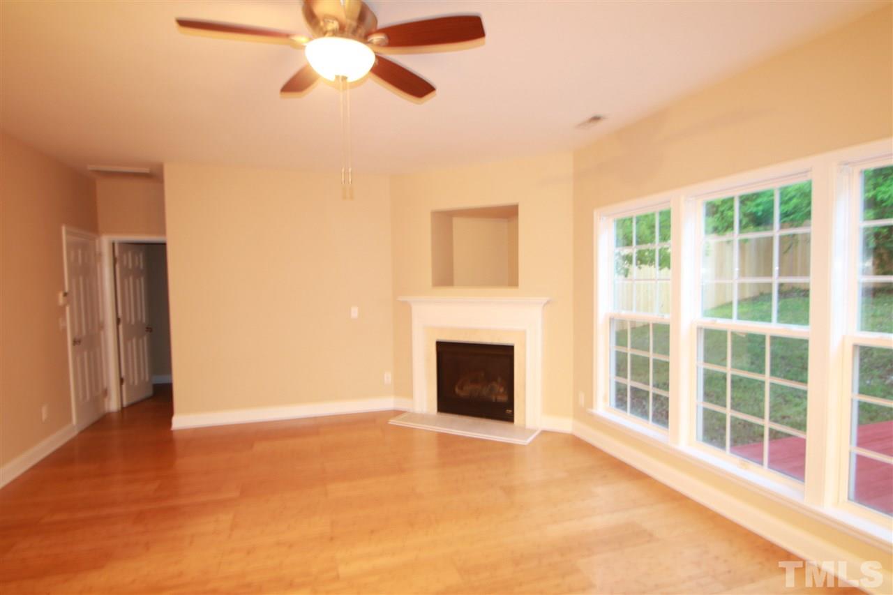 5334 Stowecroft Lane Raleigh, NC 27616 - Photo 2 of 15 a view of an empty room with a fireplace and a window