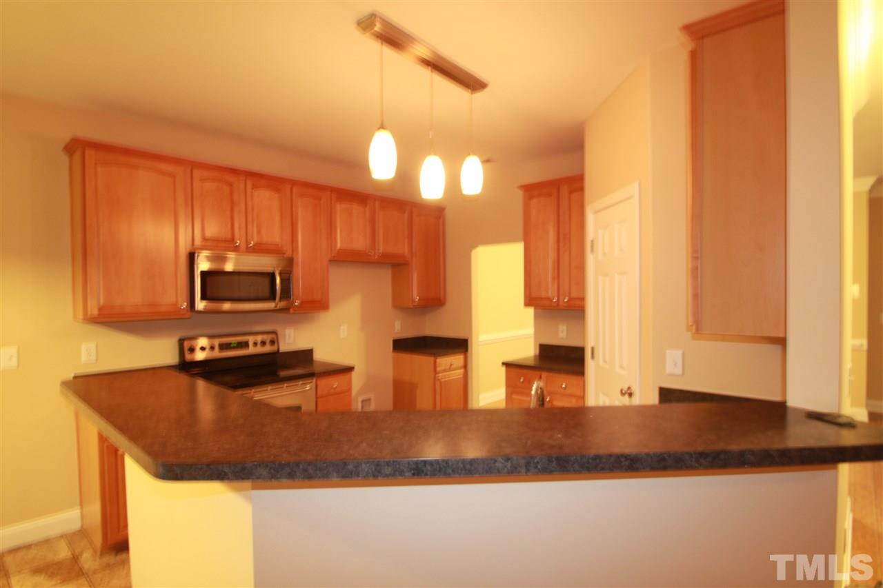 5334 Stowecroft Lane Raleigh, NC 27616 - Photo 4 of 15 a kitchen with a sink a counter top space cabinets and stainless steel appliances
