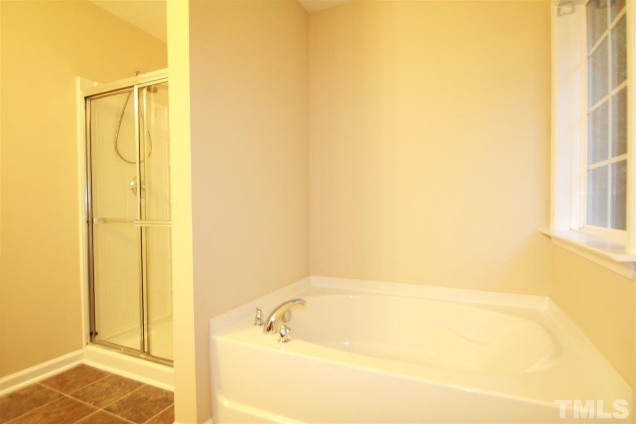 5334 Stowecroft Lane Raleigh, NC 27616 - Photo 10 of 15 a bathroom with a bathtub