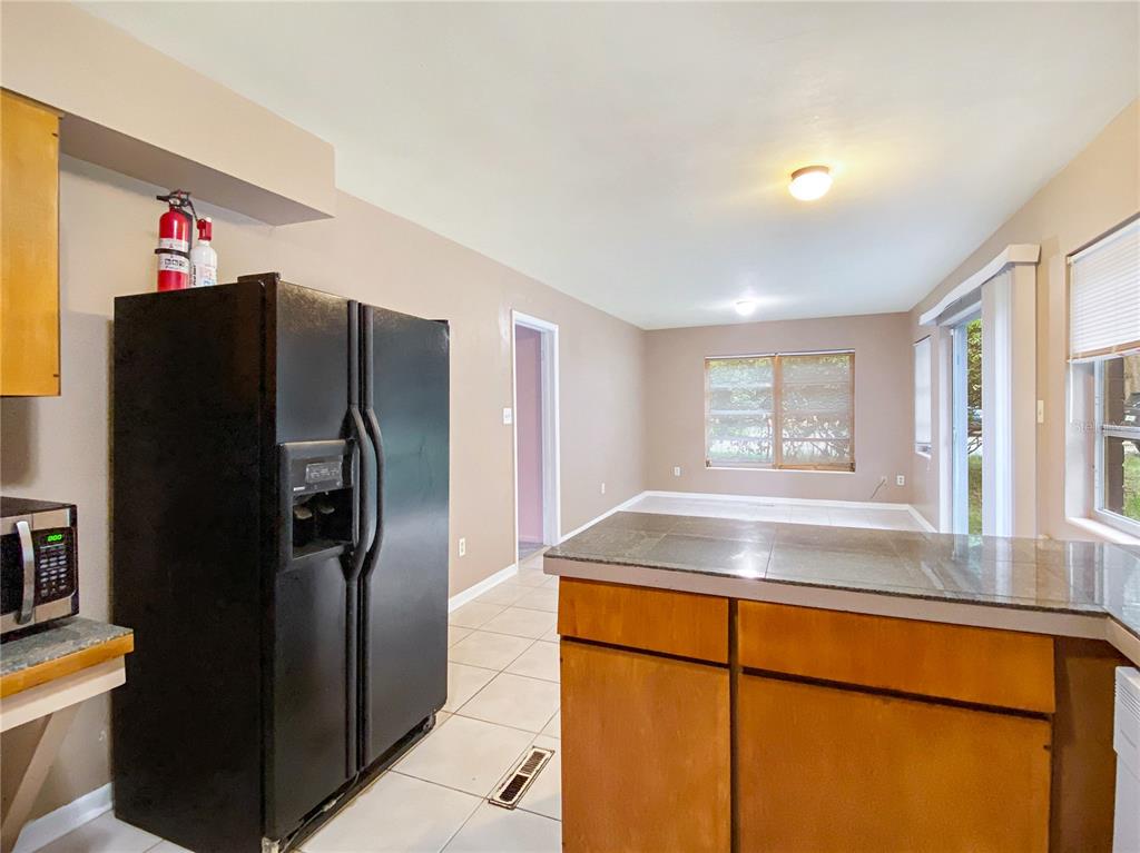 1119 Southwest 11th Avenue Gainesville, FL 32601 - Photo 13 of 30 a kitchen with stainless steel appliances granite countertop a refrigerator and a sink