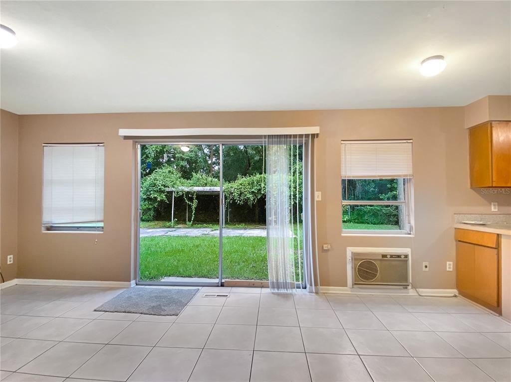 1119 Southwest 11th Avenue Gainesville, FL 32601 - Photo 29 of 30 a view of an empty room with a window and a fireplace