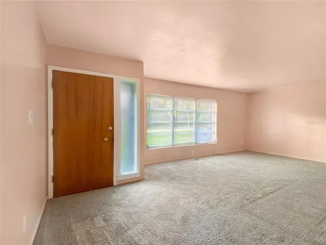 an empty room with windows and closet