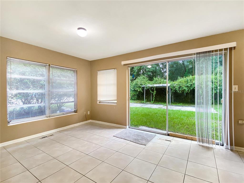 1119 Southwest 11th Avenue Gainesville, FL 32601 - Photo 5 of 30 a view of an empty room with windows and yard