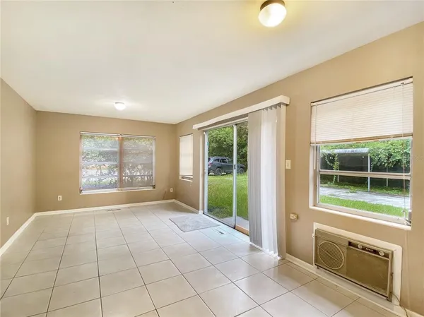 a view of a kitchen with an entryway and a living room