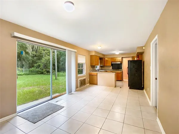 a kitchen with stainless steel appliances granite countertop wooden cabinets a sink and a large window
