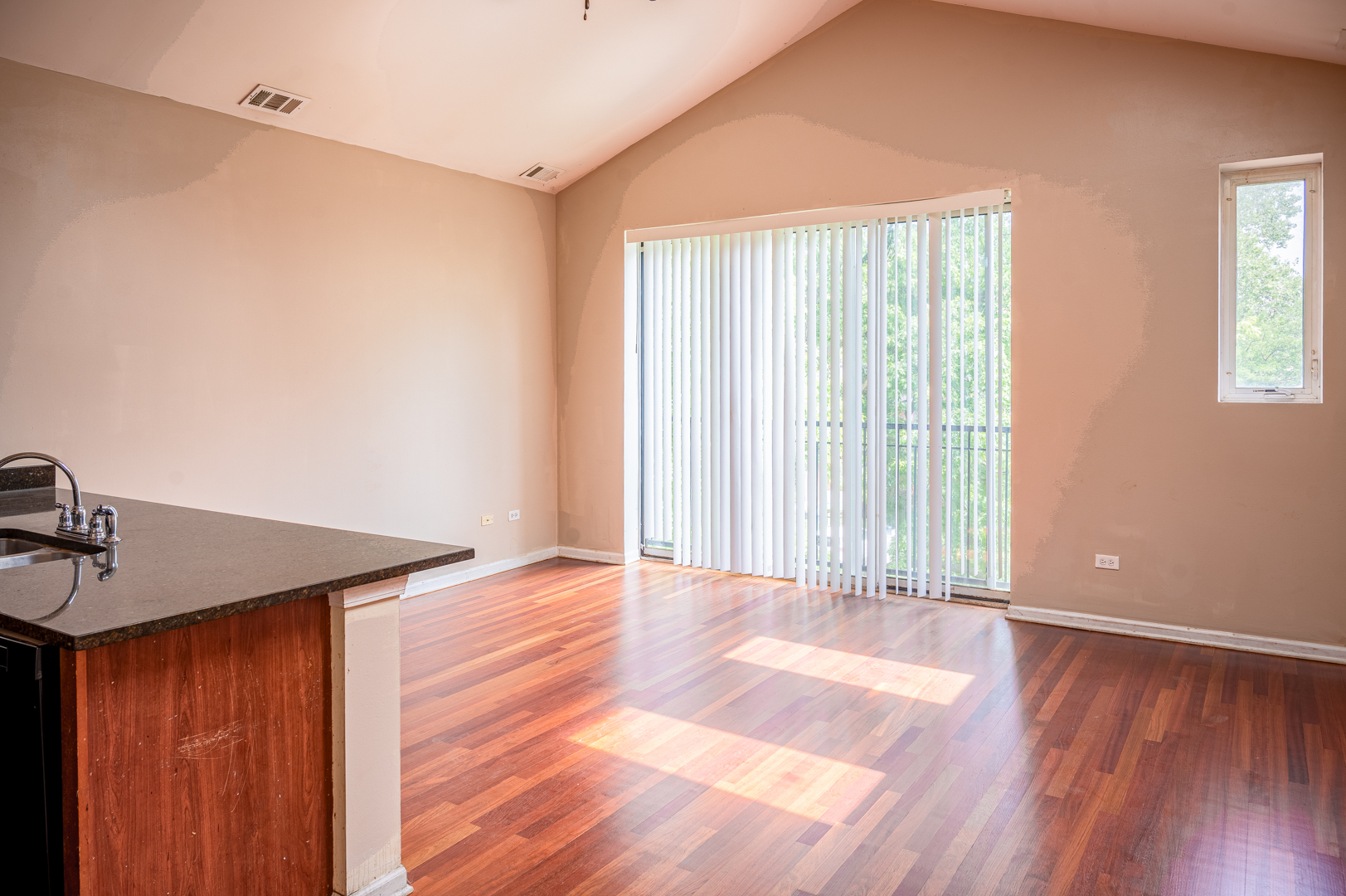 7652 South Colfax Avenue Chicago, IL 60649 - Photo 5 of 11 a view of a room with wooden floor and window