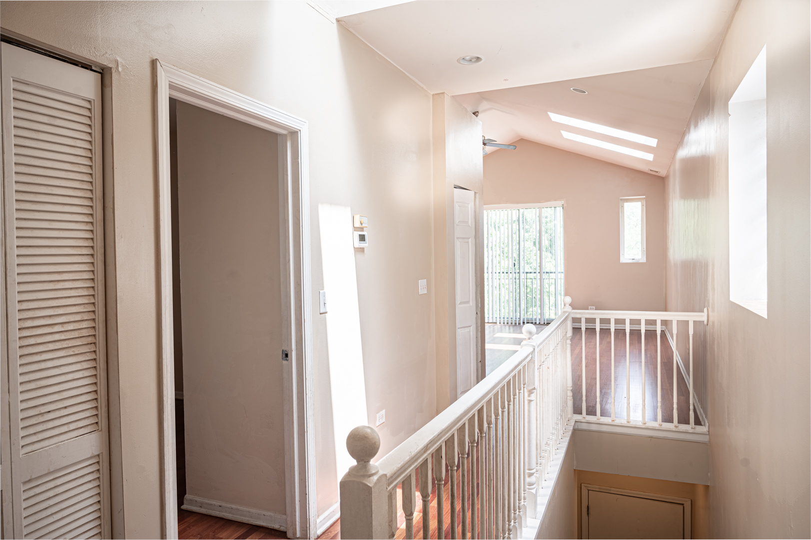 7652 South Colfax Avenue Chicago, IL 60649 - Photo 6 of 11 a view of a hallway with wooden floor and staircase