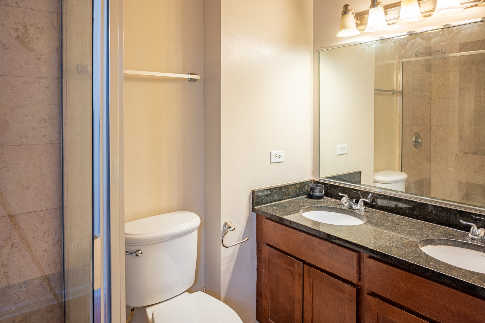 7652 South Colfax Avenue Chicago, IL 60649 - Photo 8 of 11 a bathroom with a granite countertop sink toilet and shower