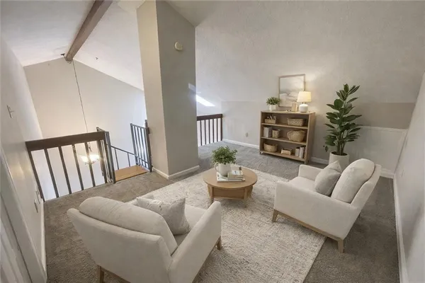 a living room with furniture fireplace and a potted plant