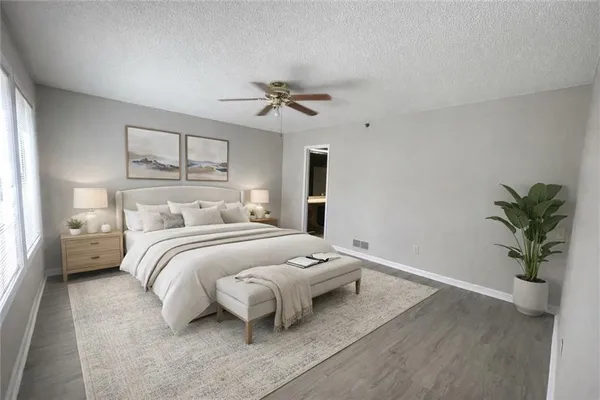 a bedroom with a bed and a potted plant