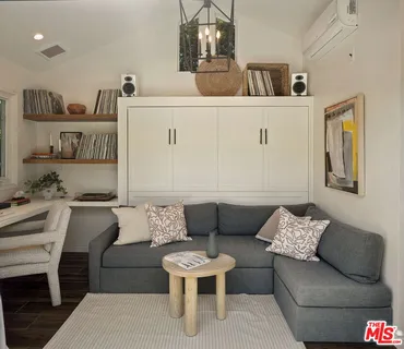 a living room with furniture and kitchen view