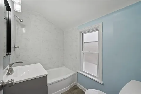 a bathroom with a sink toilet and tub
