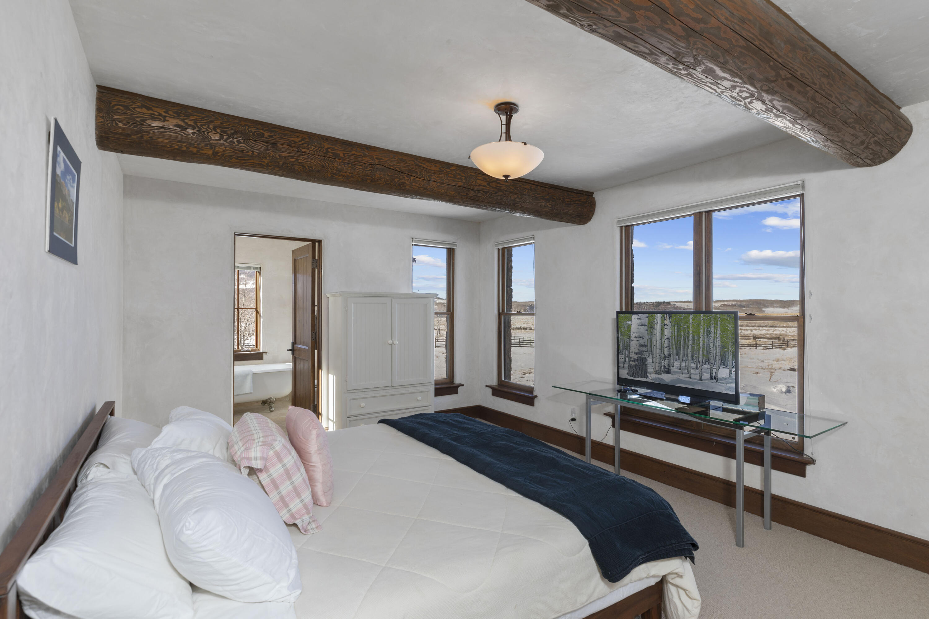 1925 East Anderson Road Placerville, CO 81430 - Photo 12 of 40 a bedroom with a bed and a chandelier