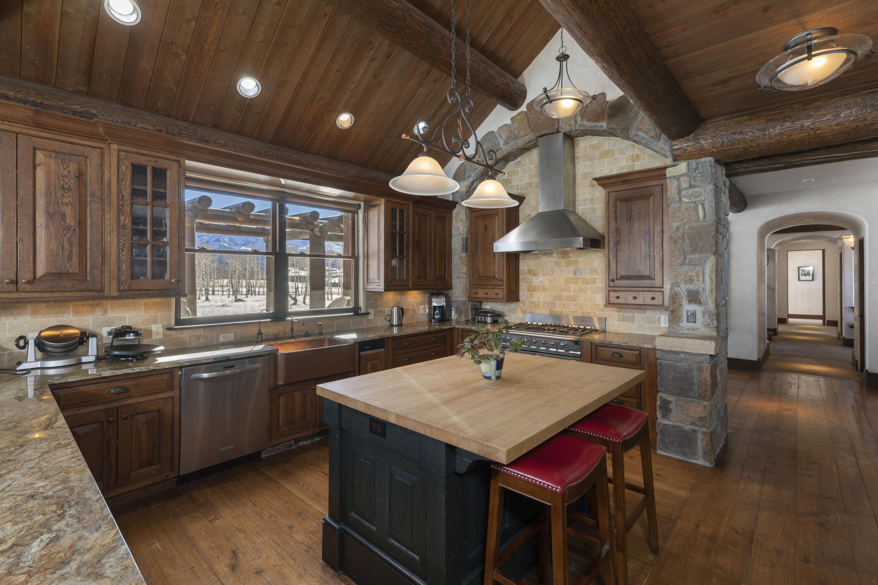 1925 East Anderson Road Placerville, CO 81430 - Photo 5 of 40 a kitchen with a stove a sink dishwasher kitchen island with chairs and wooden floor